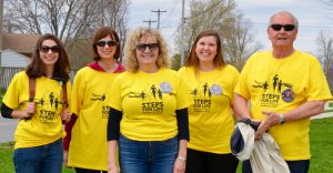 Group of smiling walkers wearing yellow t-shirts