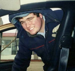 smiling man looks through an open car door