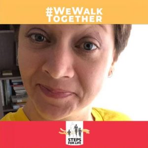 Woman with head tilted toward camera. #WeWalkTogether appears above and Steps for Life logo below.