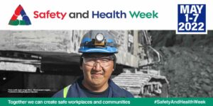 Safety and Health Week May 1-7 2022. Photo shows a miner in a mining hat.
