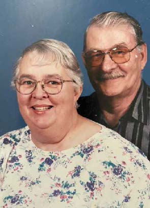 An older woman and man smile in a portrait photo