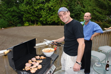 Sam Kuris, gives a smile while he attends to the barbecue.