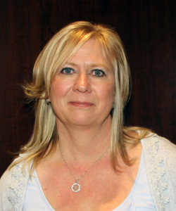 A headshot of a woman with shoulder length blonde hair. She has bright blue eyes.