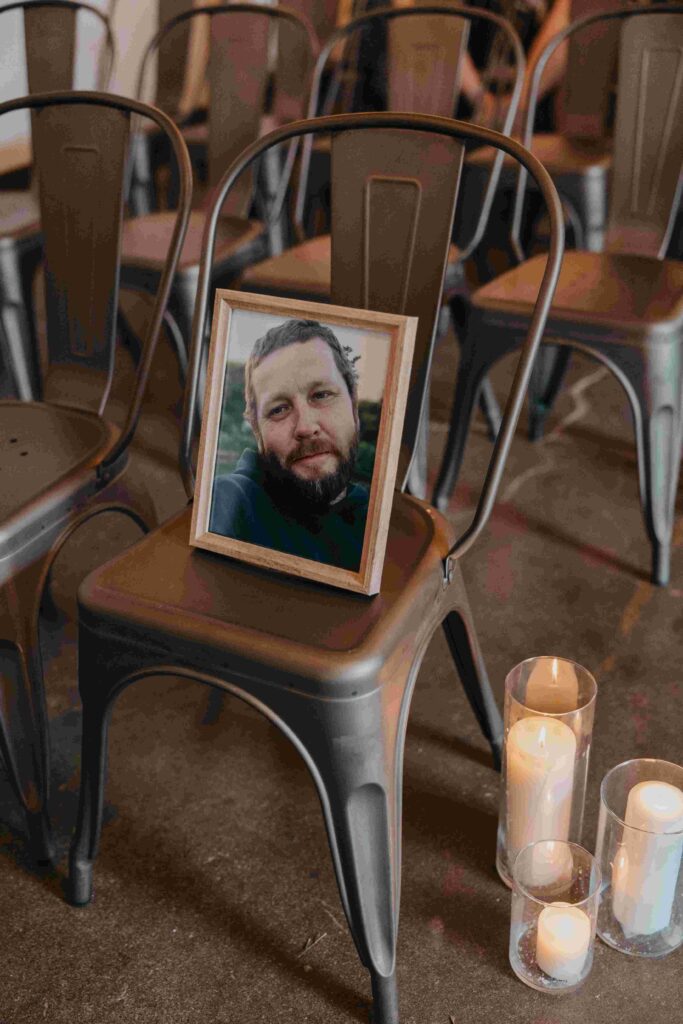 A framed photo of a man rests on one chair in a seating area.